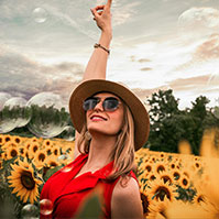 Happy homeowner in Oshawa with sun flowers in the background
